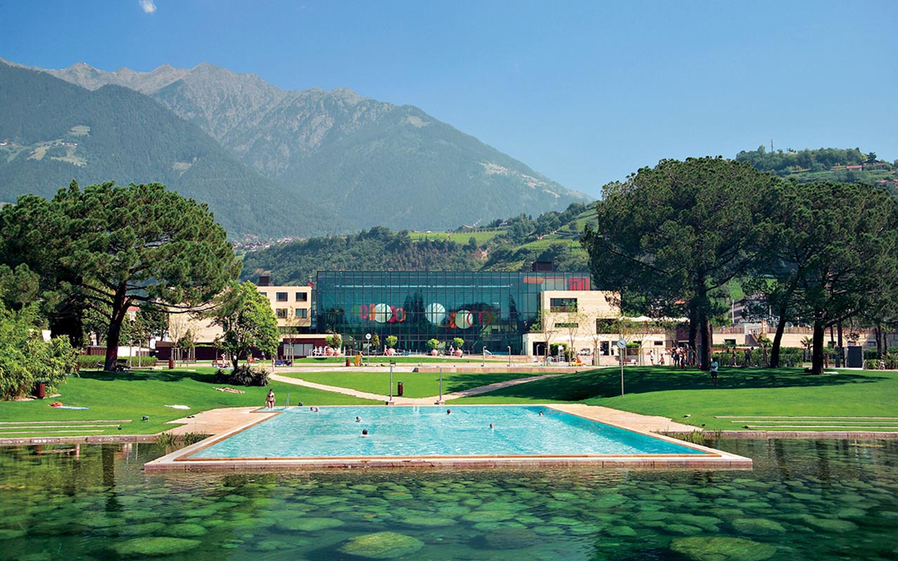 Open-air pool in the garden, SPA building and the mountains around Merano