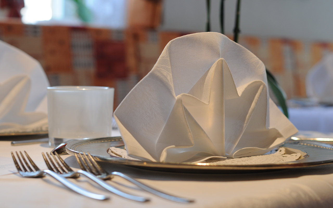 Set table with three forks, silver plate and napkin